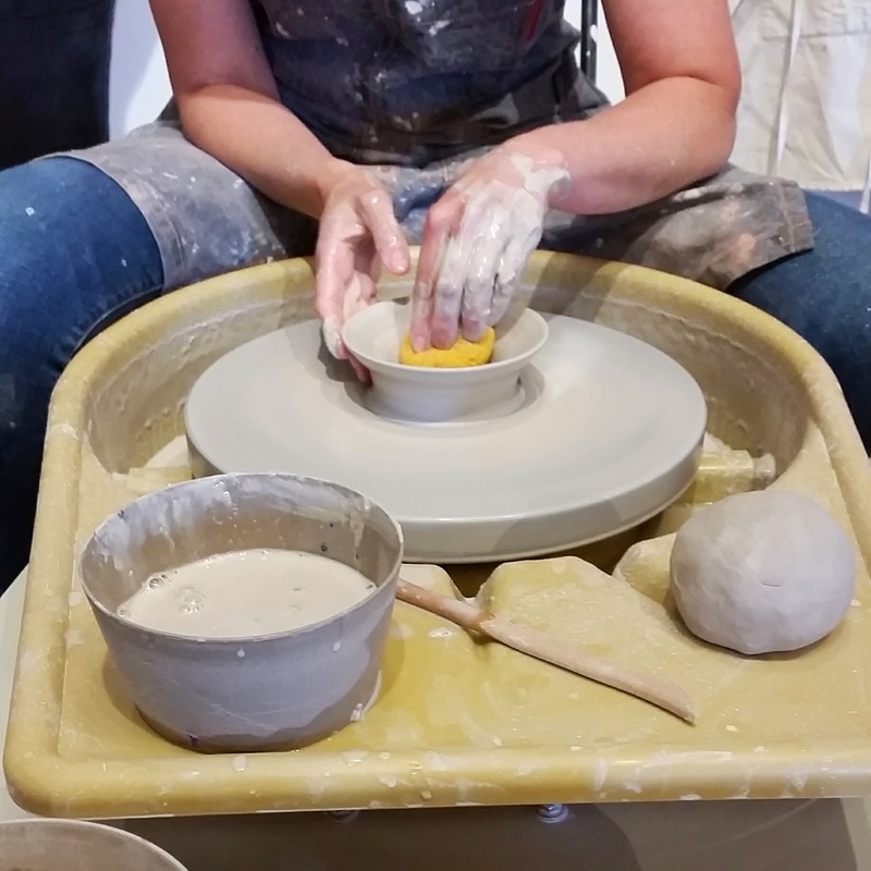 Smoothing Clay on Pottery Wheel